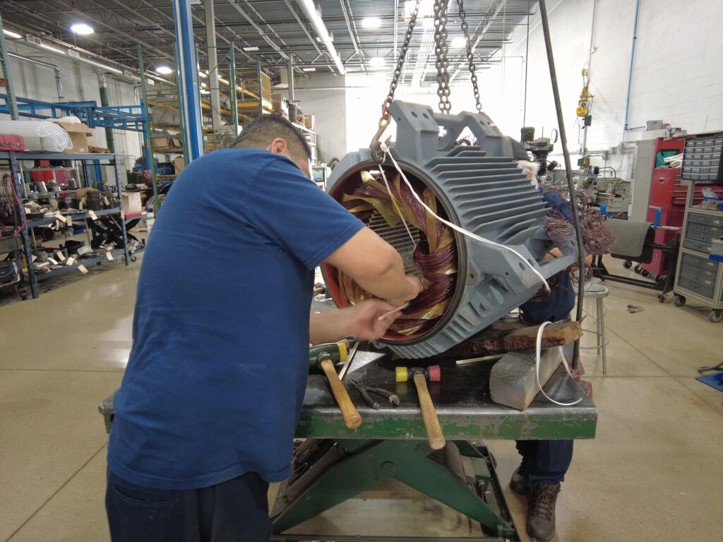 Industrial Motor Troubleshooting technician rewinding coils for electric motor repair