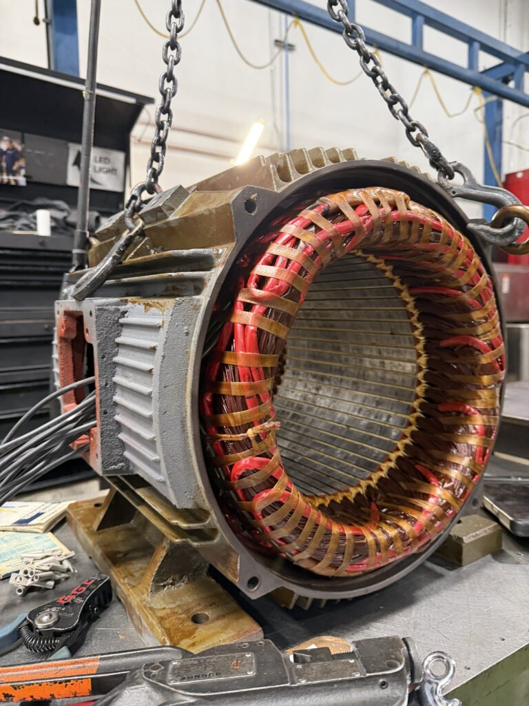 Industrial motor stator rewound with new red leads and coil lacing