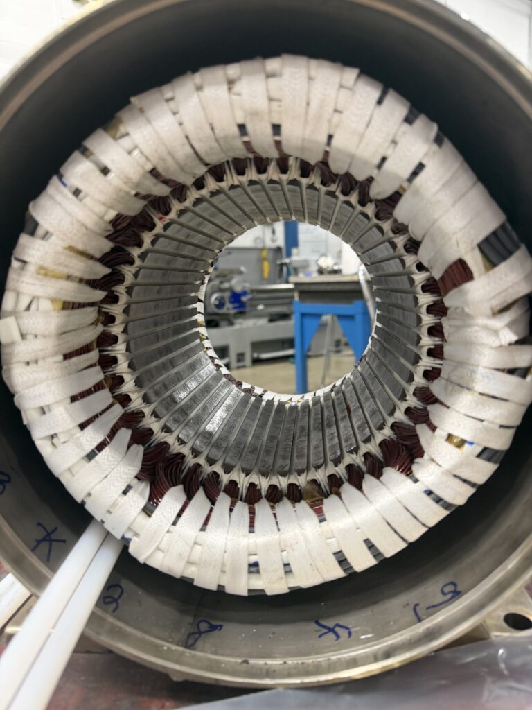 Freshly rewound stator viewed through the bore, ready for varnish